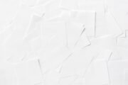 Overhead view of scattered white paper sheets creating an abstract pattern.